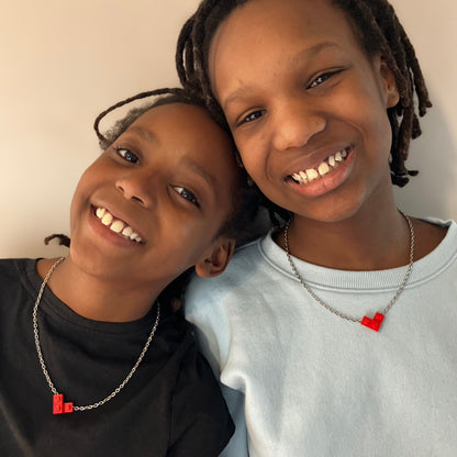 two kids wearing matching Red valentine heart necklaces made from Lego® pieces