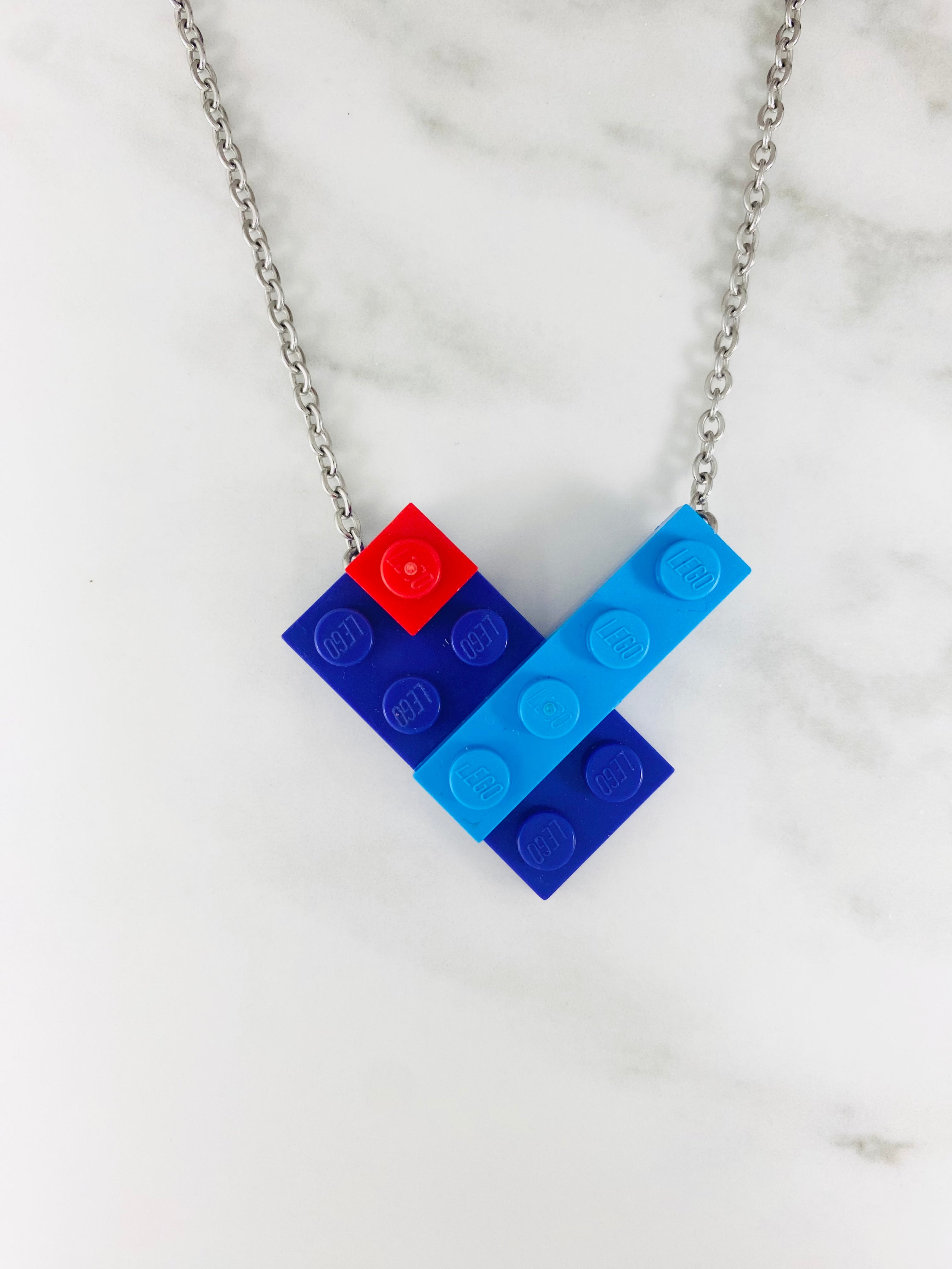 Blue and light blue Tu Snaps necklace made from Lego pieces with an extra added red Lego piece