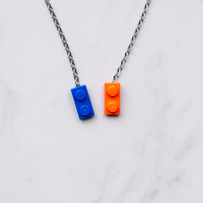 Necklace with blue and orange brick pendants on a light gray background