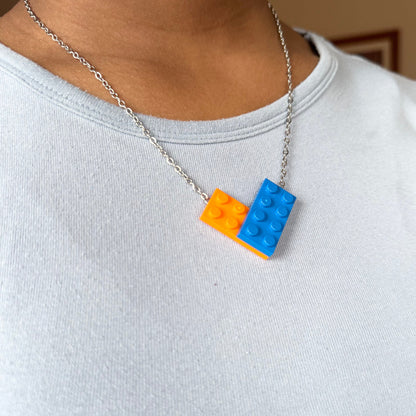 Necklace with orange and blue brick pendants on a person